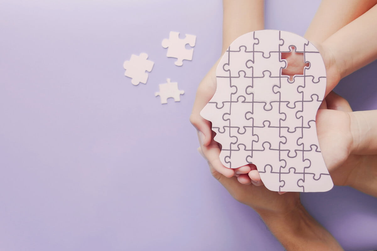 Brain-shaped puzzle being hold by various hands