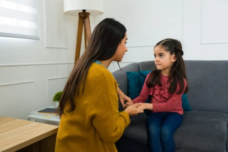 Mother talking with daughter about a serious topic.