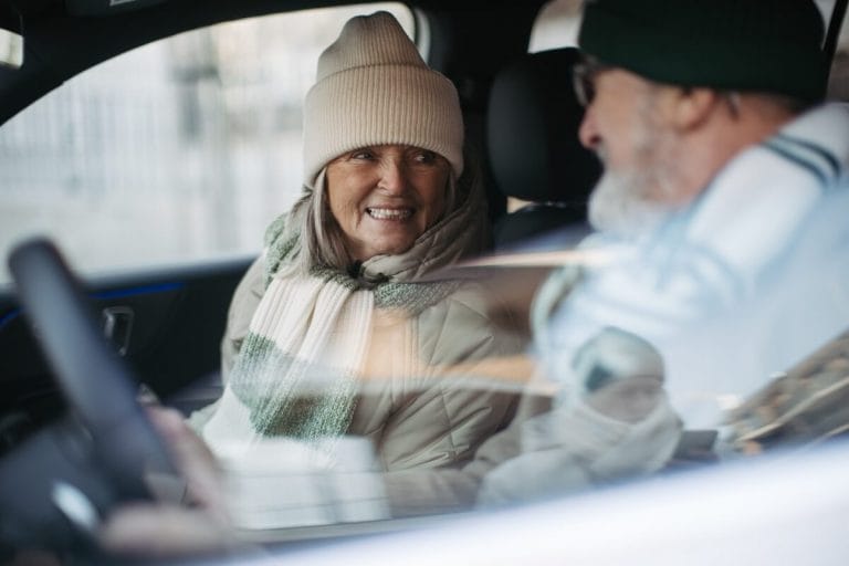 Older couple traveling by car.