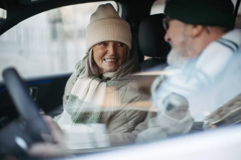 Older couple traveling by car.